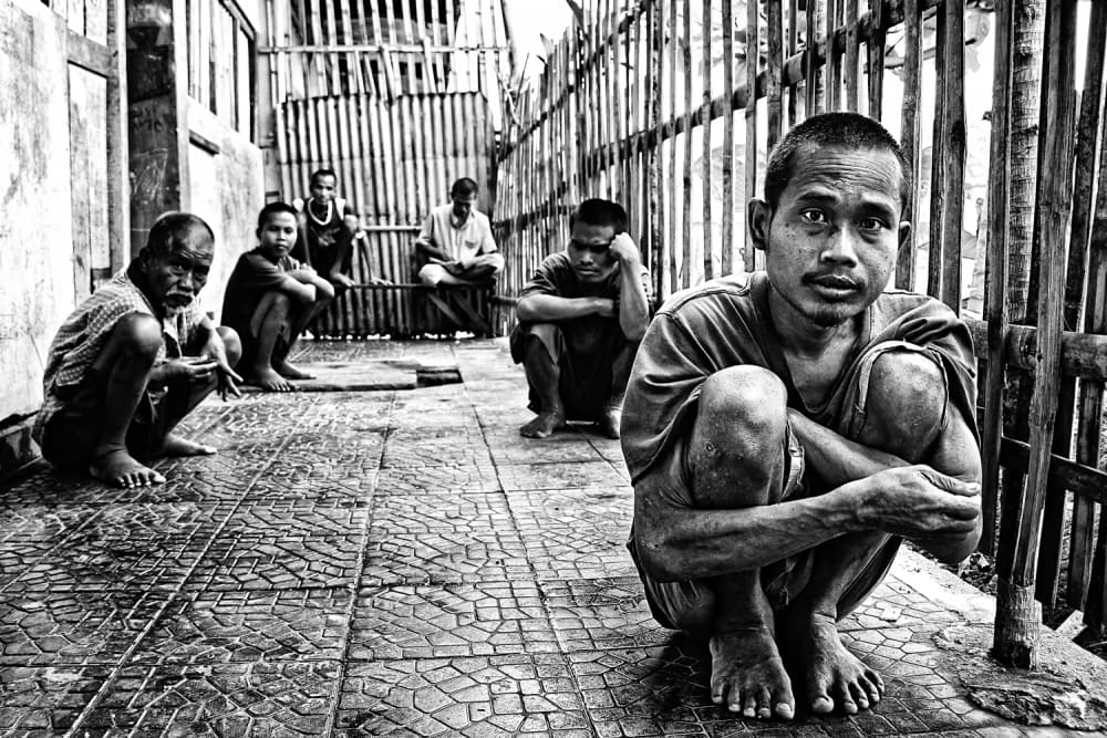 Pensive Men Squatting by m salim bhayangkara — canvas wall art
