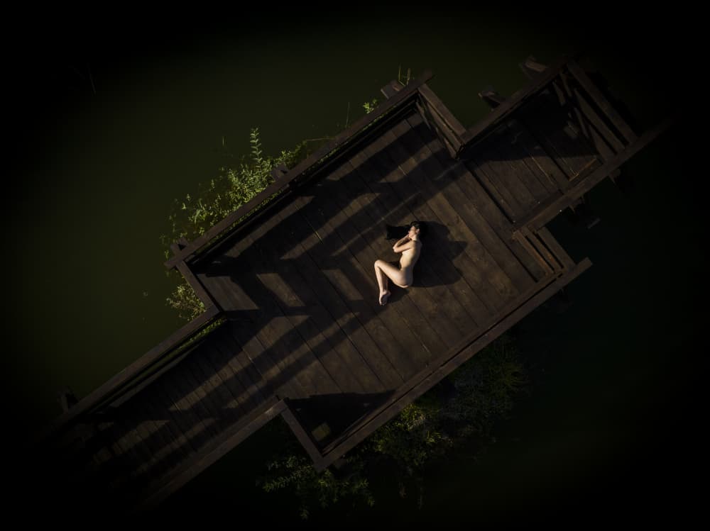 Woman on Dark Dock by Ovi D. Pop — canvas wall art