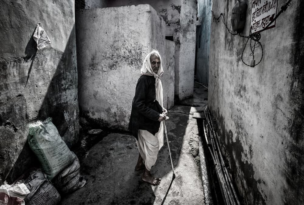 Elderly Woman Alleyway by Joxe Inazio Kuesta Garmendia — canvas wall art