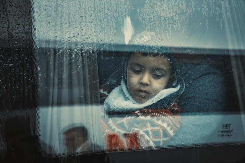 Child at Rainy Window by M. Emre Erol — canvas wall art