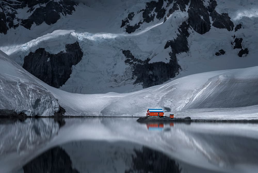Orange Cabin Frozen Lake by John-Mei Zhong — canvas wall art
