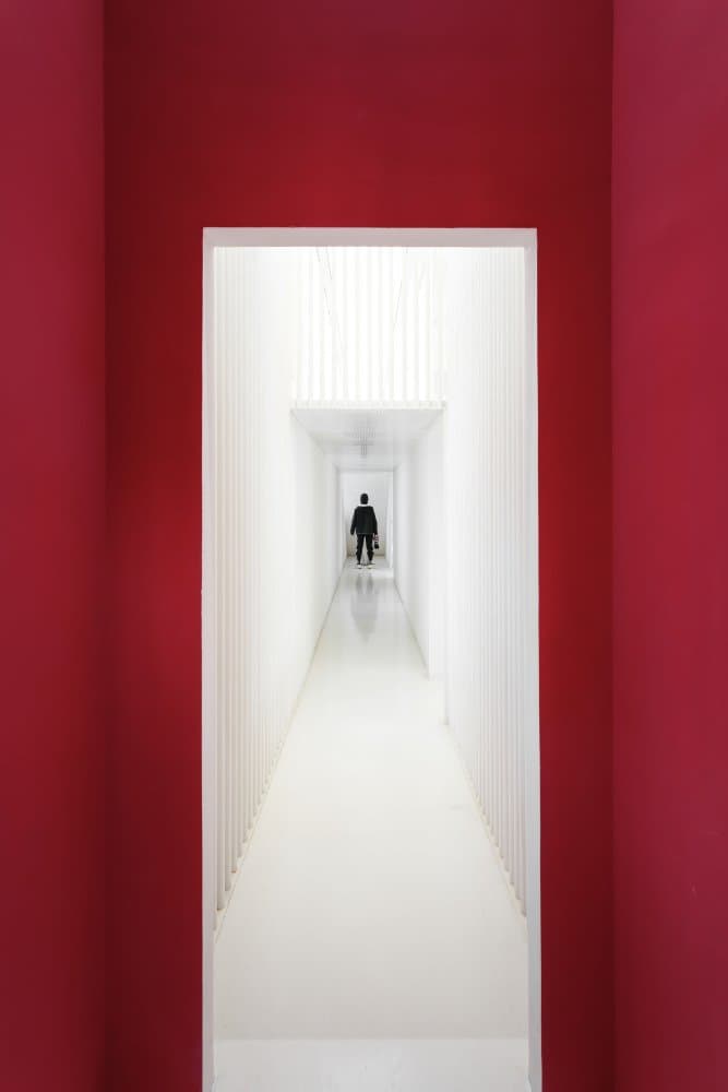 Red Corridor Lone Figure by Yifan Wu — canvas wall art