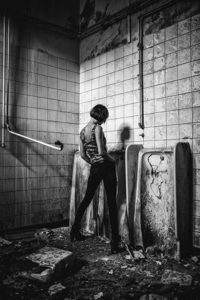 Woman By Gritty Urinals by Georgios Bero — canvas wall art