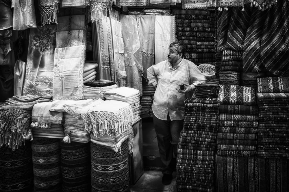 Market Shopkeeper's Moment by Pavol Stranak — canvas wall art