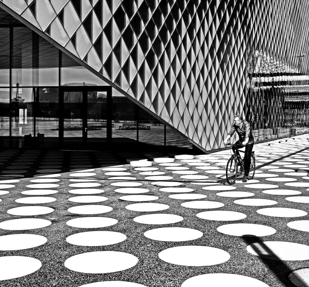 Geometric City Cyclist by Julien Oncete — canvas wall art
