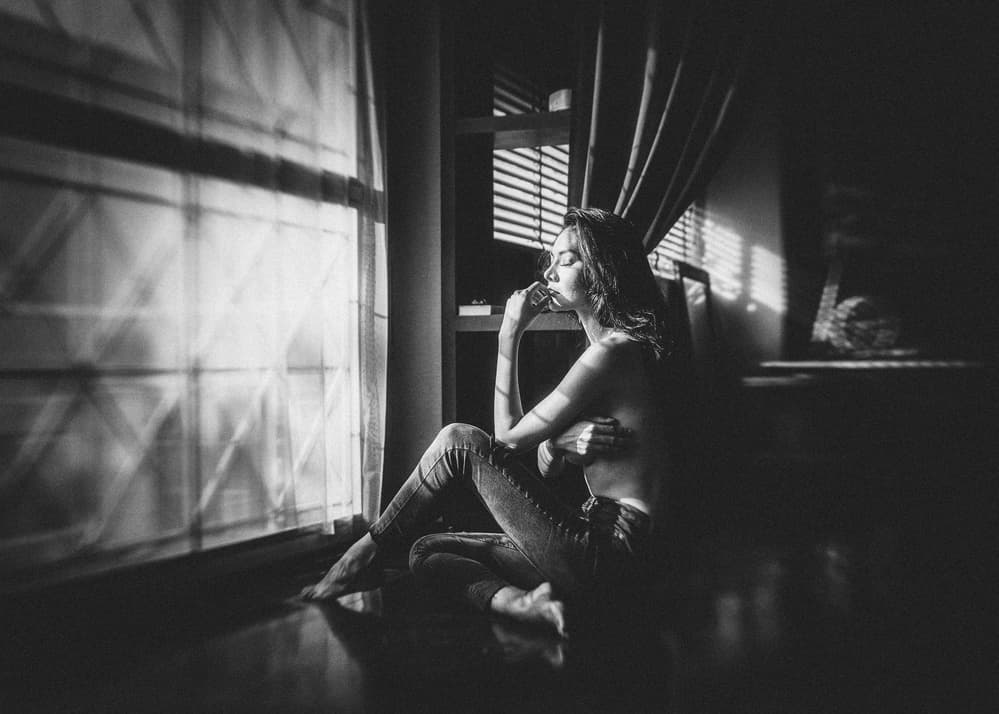 Pensive Woman Window Light by ADIREK M — canvas wall art