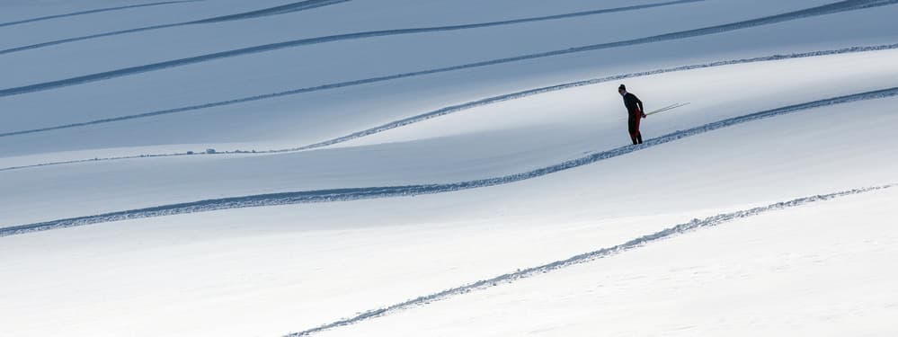 Lone Skier Winter Slope by Matej Rumansky — canvas wall art
