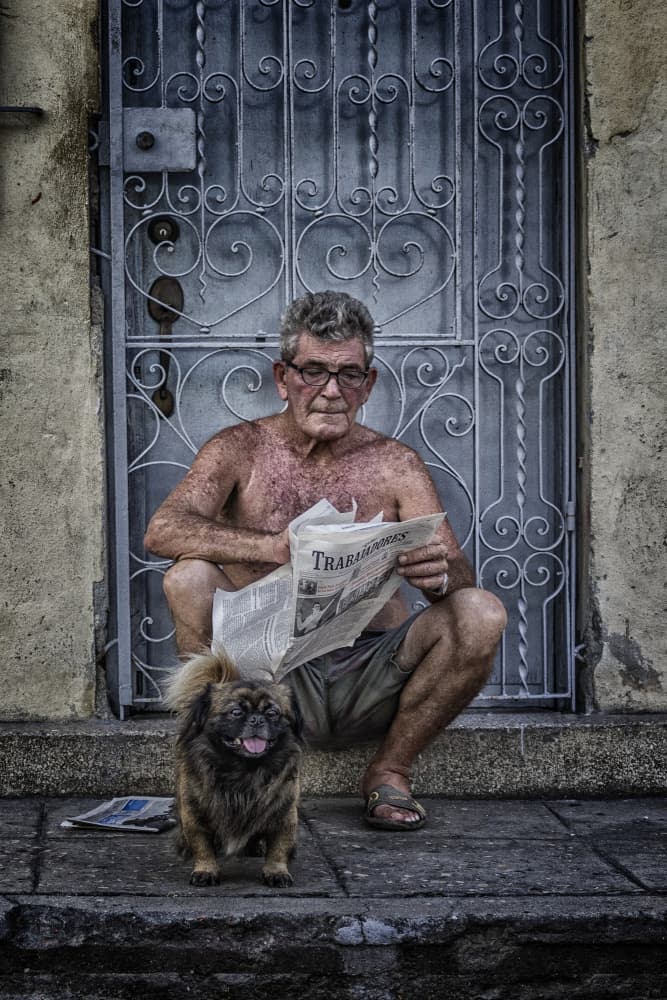 Man and Dog Reading by Pavol Stranak — canvas wall art