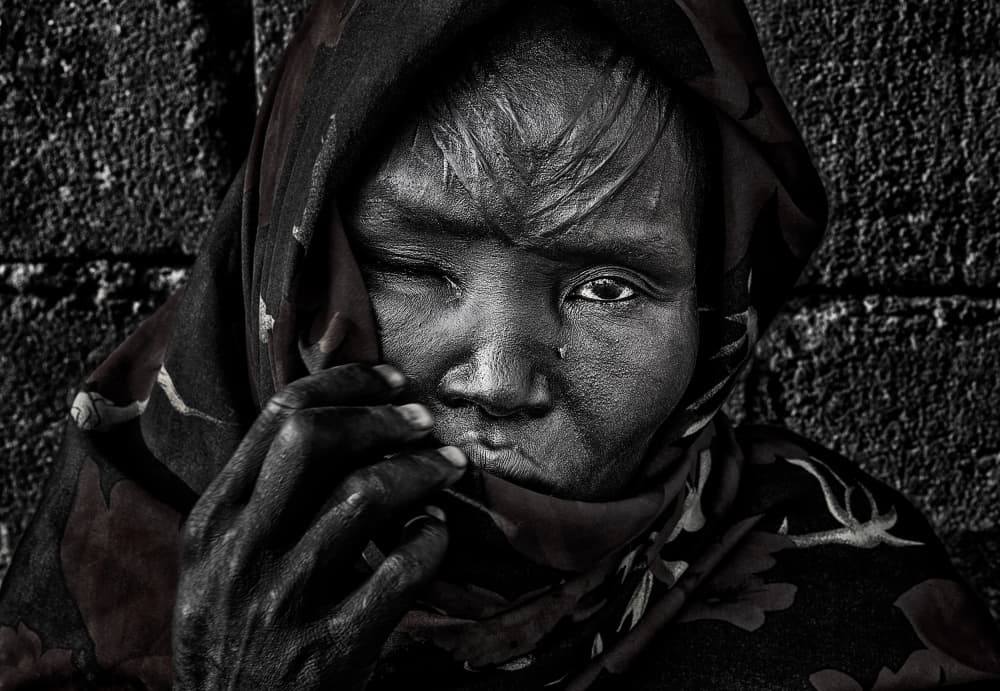 Woman's Somber Gaze by Joxe Inazio Kuesta Garmendia — canvas wall art