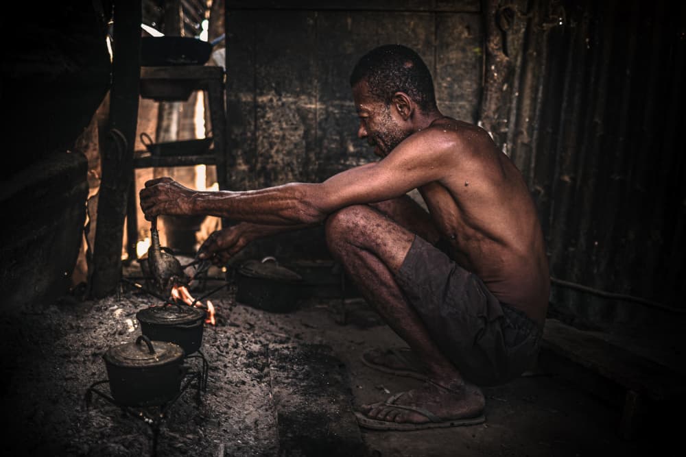 Man Cooking Over Fire by Marco Tagliarino — canvas wall art