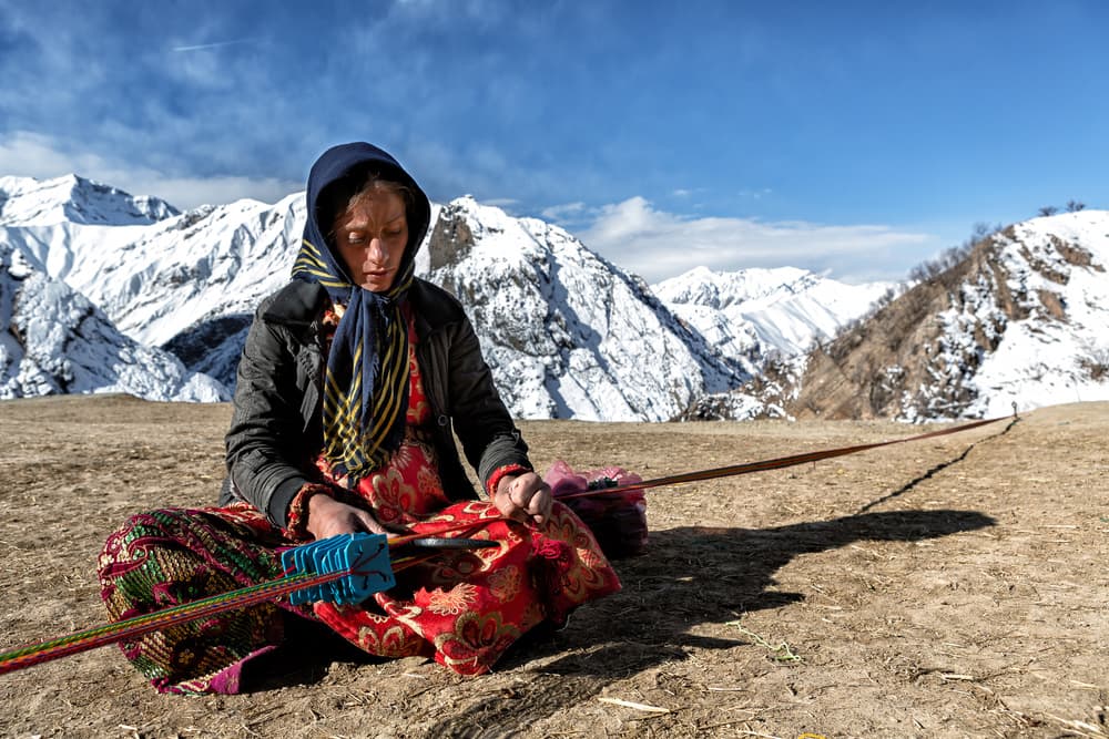 Woman Weaving Snowy Mountains by Mohammadreza Momeni — canvas wall art