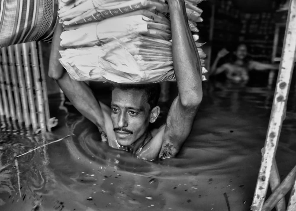 Man Carries Through Flood by Avishek Das — canvas wall art