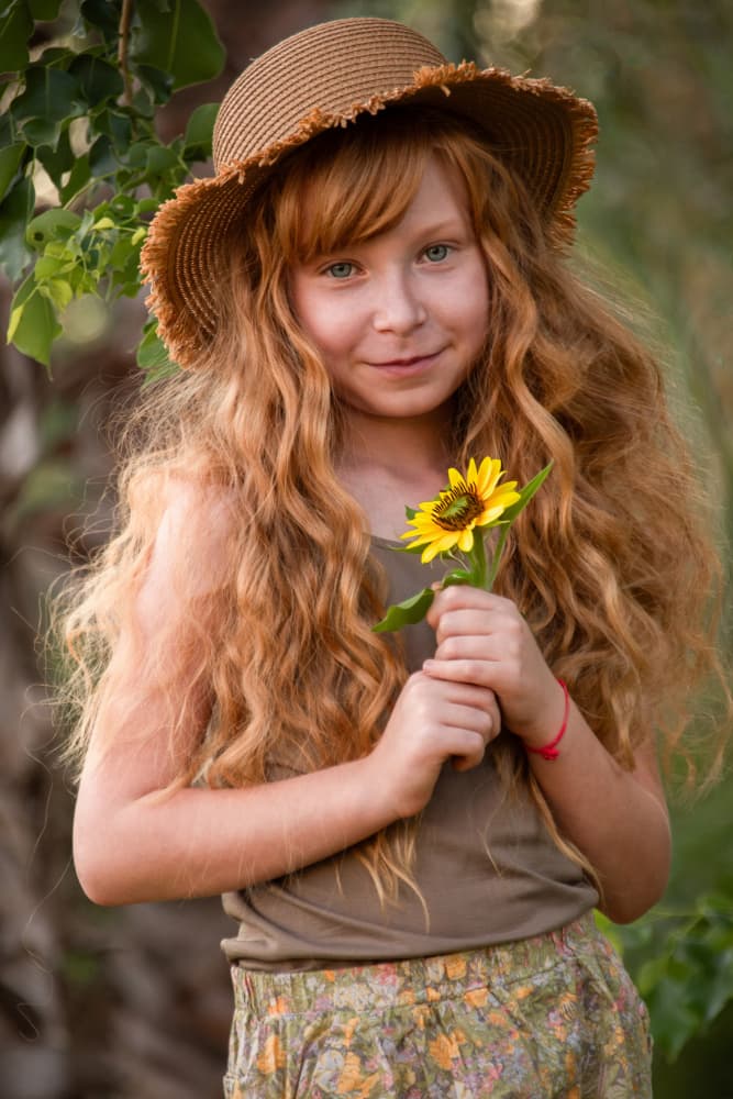 Smiling Redhead with Sunflower by Svetlana Kirzh — canvas wall art