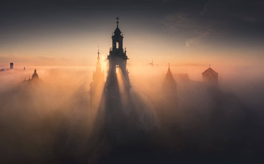 Sun Rays Over Foggy City by Karol Nienartowicz — canvas wall art