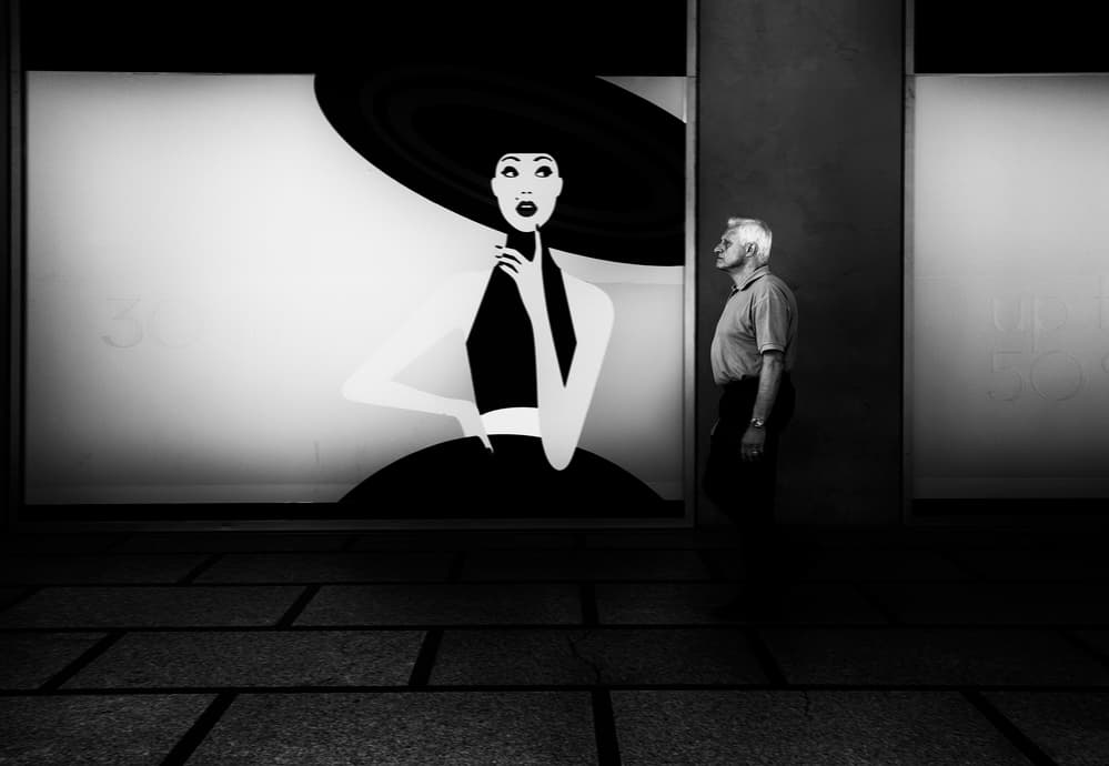 Man By Hat Lady by Julien Oncete — canvas wall art