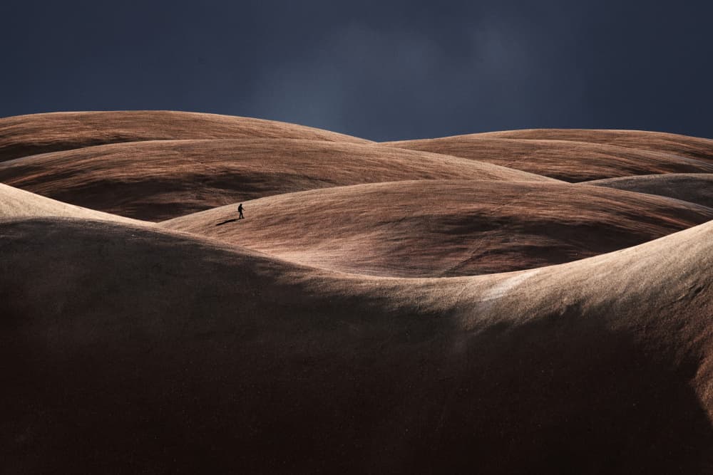 Lone Figure Rolling Hills by Ibrahim Nabeel — canvas wall art