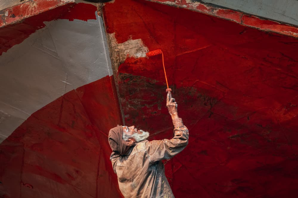 Worker Painting Red Boat by Richard Huang — canvas wall art
