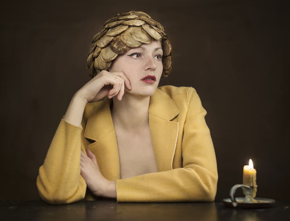 Contemplative Woman Golden Hat by Michael Allmaier — canvas wall art