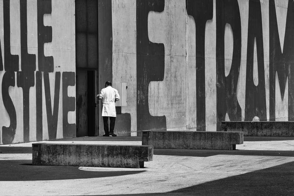 Man by Lettered Wall by Luc Vangindertael (laGrange) — canvas wall art