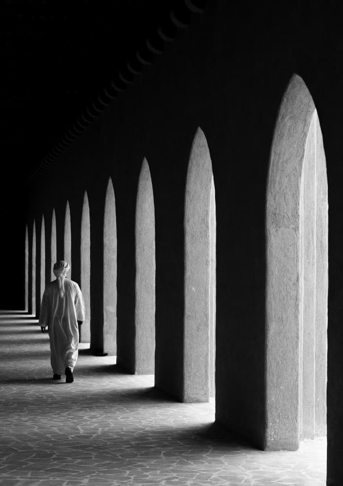 Man Walks Through Arches by Karim Al Thahaby — canvas wall art