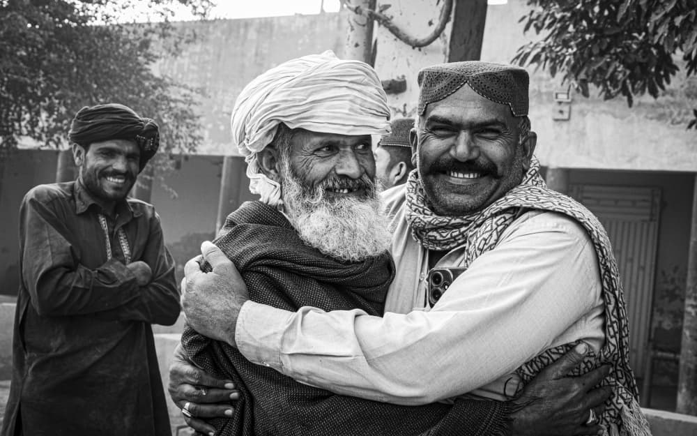 Joyful Men Embracing by Elena Molina — canvas wall art
