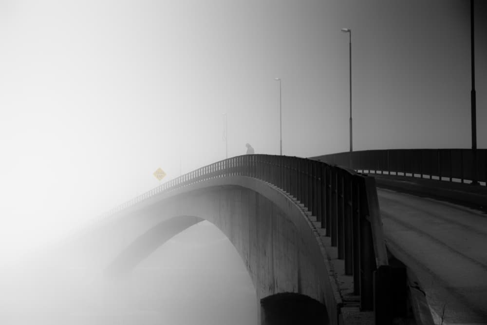 Lone Figure Foggy Bridge by Lior Yaakobi — canvas wall art