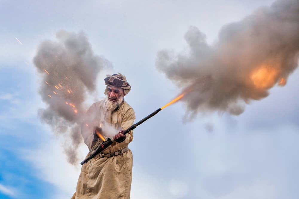 Old Man Firing Rifle by Haitham AL Farsi — canvas wall art