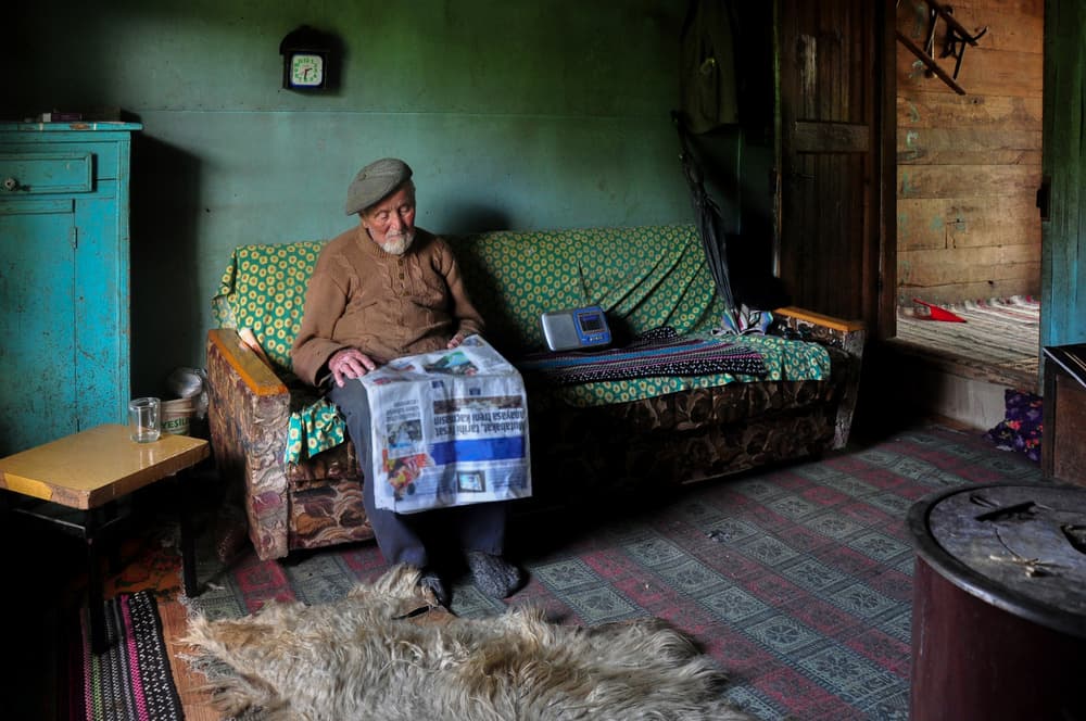 Old Man Reads Newspaper by Fatma GÖKMEN — canvas wall art