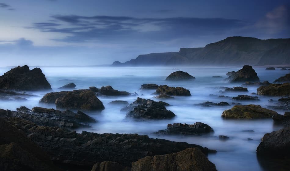 Blue Hour Rocky Coast by Norbert Maier — canvas wall art