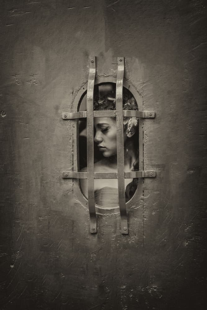Pensive Woman Behind Bars by Antonyus Bunjamin (Abe) — canvas wall art