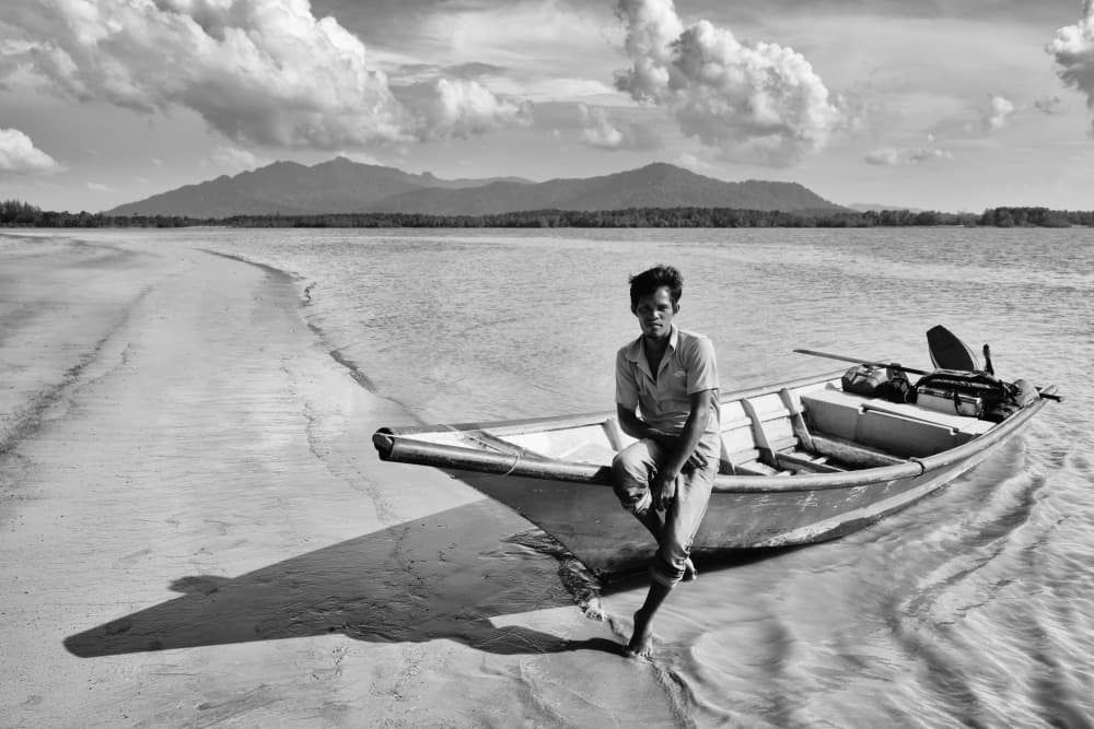 Man By Boat Shore by Kieron Long — canvas wall art