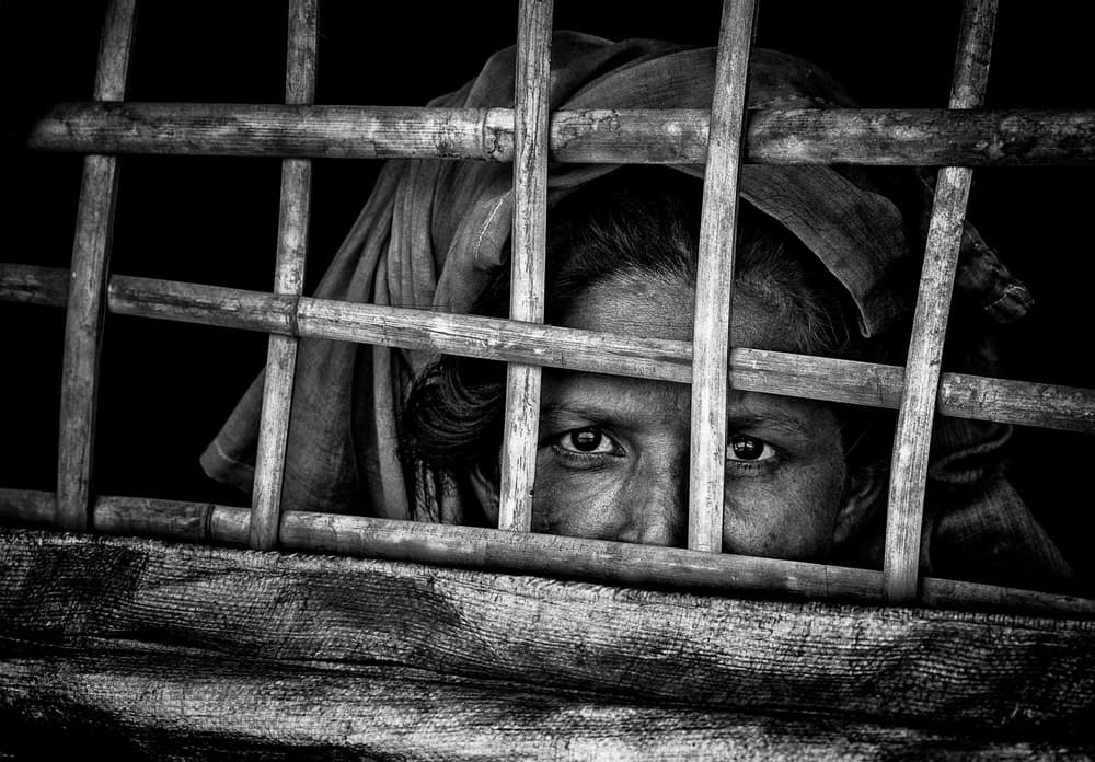 Woman's Gaze Through Bars by Joxe Inazio Kuesta Garmendia — canvas wall art