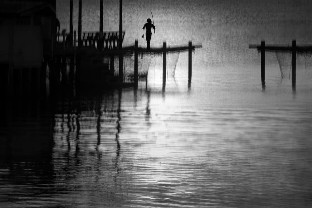 Lone Fisherman Silhouette by Ekkachai Khemkum — canvas wall art