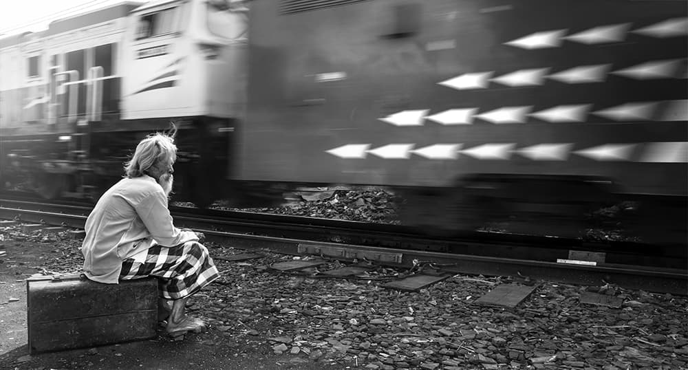 Woman Watches Passing Train by Sebastian Kisworo — canvas wall art