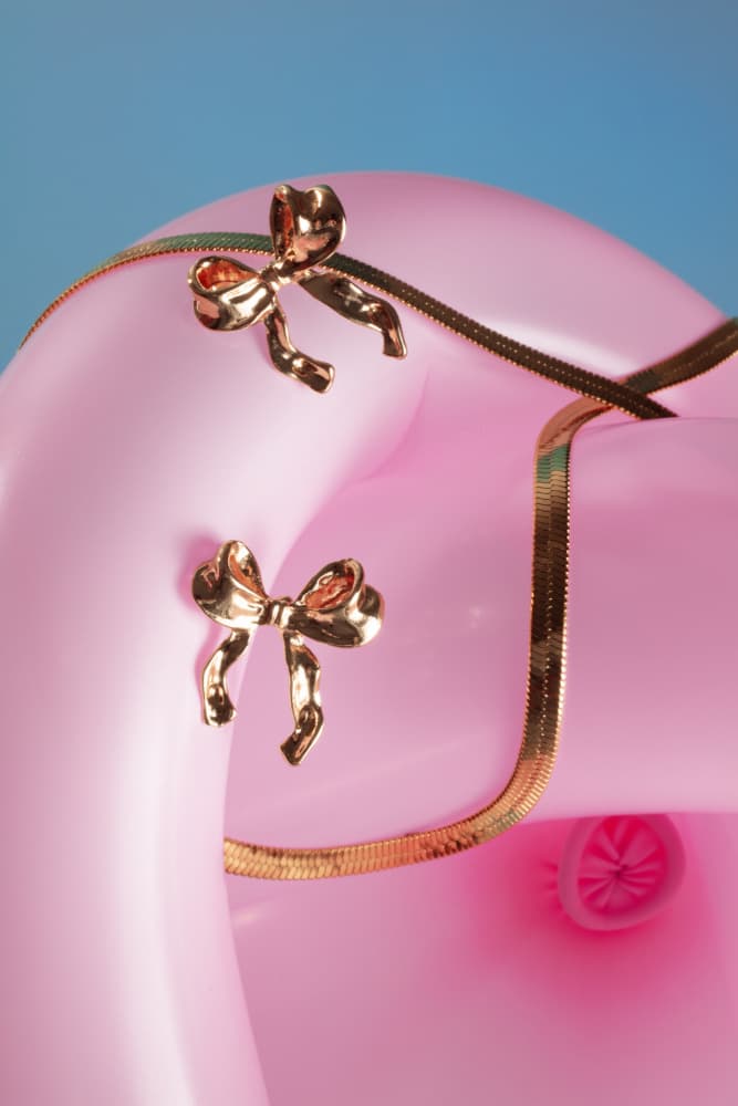Golden Bows on Pink by Julia Ramiro — canvas wall art