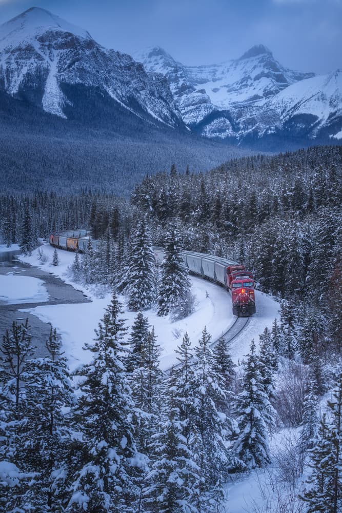 Train Through Winter Mountains by Yongnan Li (李永男) — canvas wall art