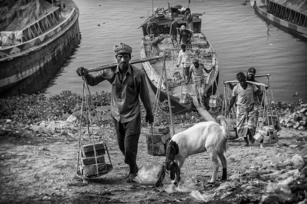 River Workers With Goat by Elena Molina — canvas wall art