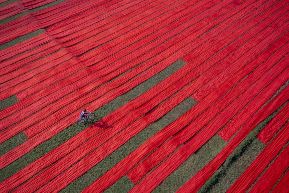 Cycling Through Red Fabric by Azim Khan Ronnie — canvas wall art