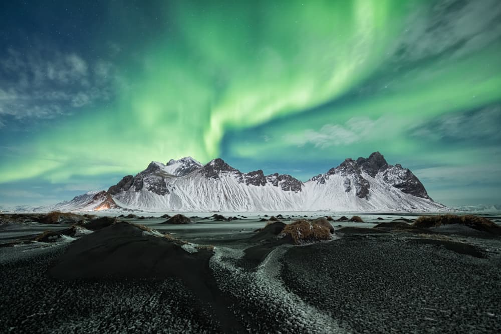 Northern Lights Over Snowy Peaks by Bjoern Alicke — canvas wall art