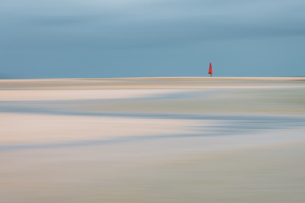 Lone Red Sail Beach by Renate Wasinger — canvas wall art