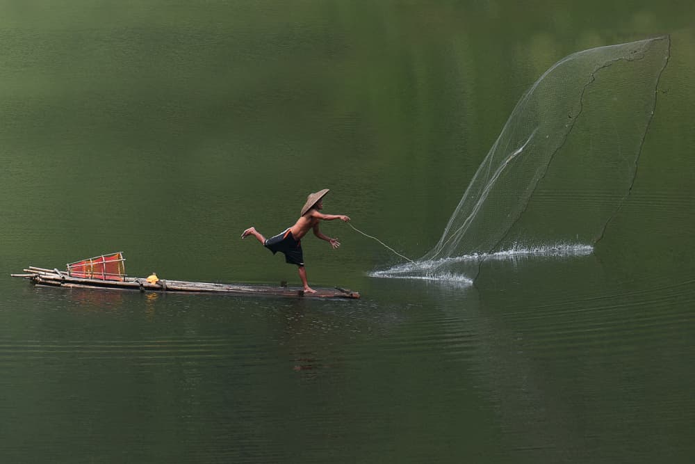 Fisherman Casting Net by Ajar Setiadi — canvas wall art