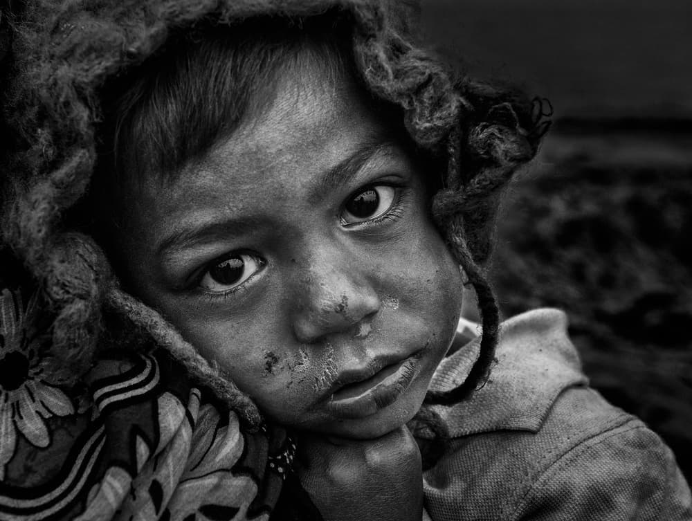 Child's Somber Gaze by Joxe Inazio Kuesta Garmendia — canvas wall art