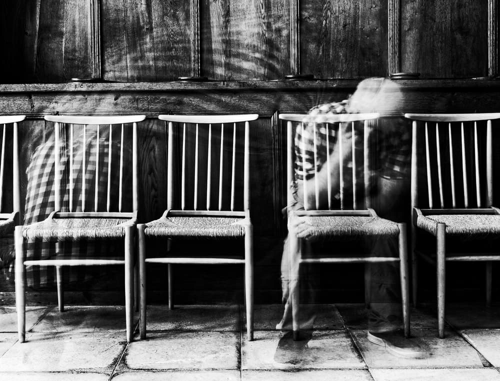 Ghostly Figure Among Chairs by Jürgen Hartlieb — canvas wall art