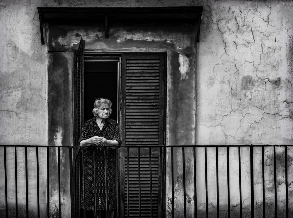 Elderly Woman on Balcony by Ömer Ates Kızıltug — canvas wall art