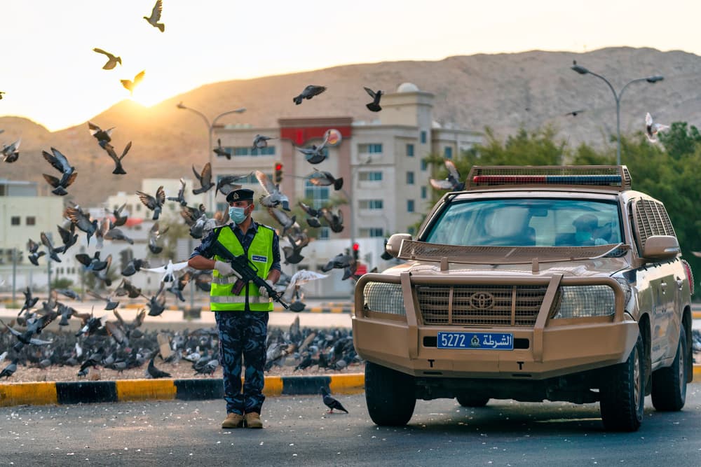 Officer and Pigeons at Sunset by Haitham AL Farsi — canvas wall art