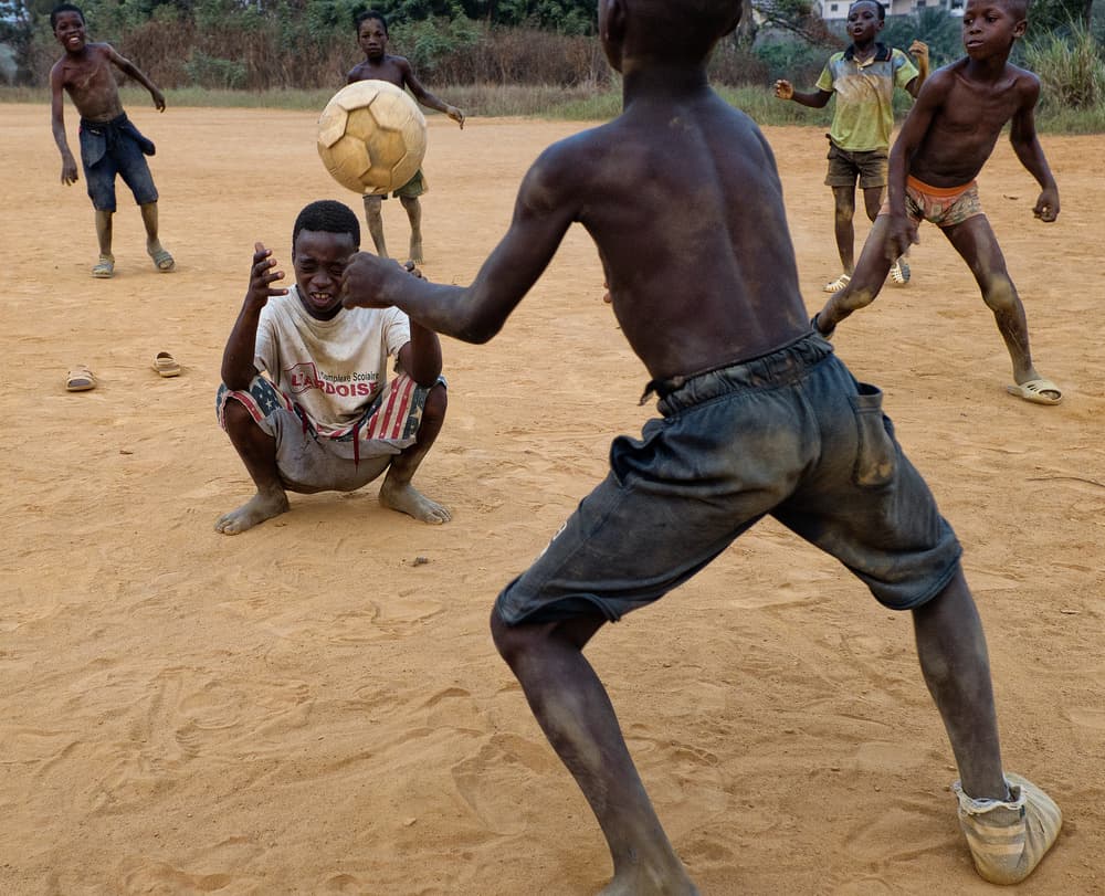 Boys Playing Football by Lorenzo Grifantini — canvas wall art