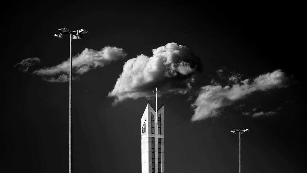 Stark Church and Clouds by Karol Važan — canvas wall art