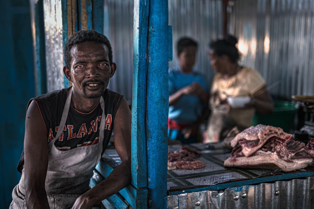 Smiling Market Vendor by Marco Tagliarino — canvas wall art