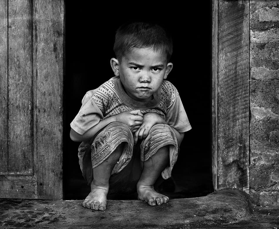 Young Boy's Intense Gaze by Sebastian Kisworo — canvas wall art