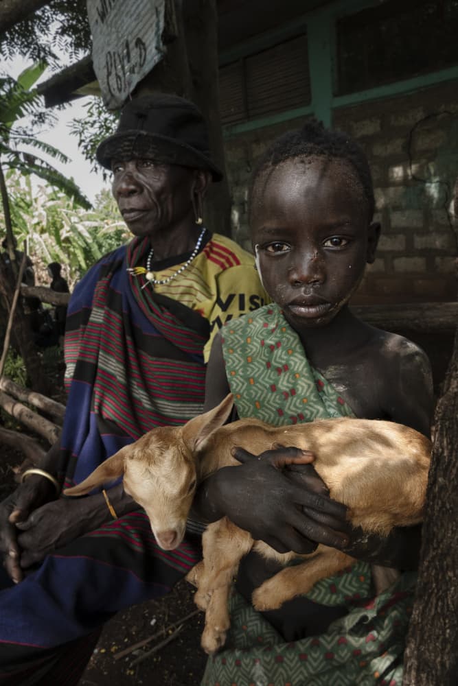 African Child and Goat by Elena Molina — canvas wall art